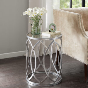 Update your home decor with the modern flair of the Madison Park Arlo Metal Eyelet Accent Table. This round metal accent table flaunts a geometric design with a grey metal finish to create a stunning contemporary look. A clear