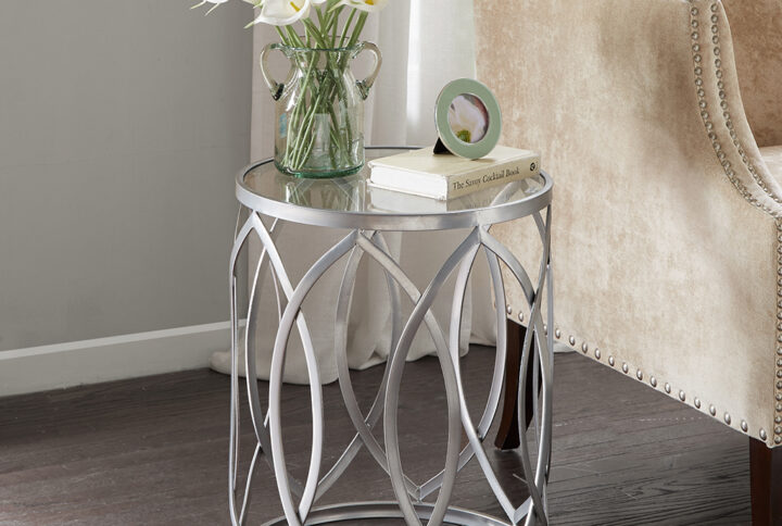 Update your home decor with the modern flair of the Madison Park Arlo Metal Eyelet Accent Table. This round metal accent table flaunts a geometric design with a grey metal finish to create a stunning contemporary look. A clear