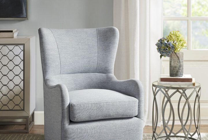 The Madison Park Arianna Swivel Glider Chair offers a simple yet sleek look for your living room décor. This swivel glider chair features a high swoop wing back and removable seat cushion that embodies comfort and a chic style. The light blue upholstery makes it easy to pair this swivel chair with most décors