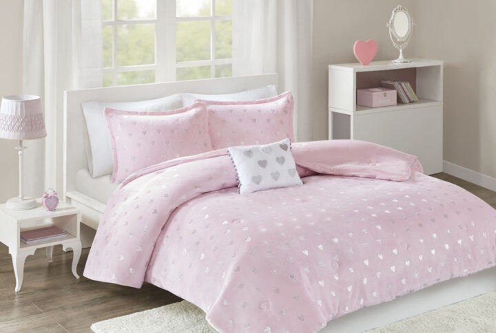 The Mi Zone Rosalie Metallic Printed Plush Comforter Set brings a bright and casual update to your bedroom. A silver metallic heart print adorns the pink plush comforter and shams (1 in Twin/TwinXL) creating a soft and fun look. An oblong decorative pillow with a pompom trim and hearts adds a lovely touch to the bedding set. This bedding set is also OEKO-TEX certified