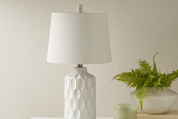 The INK+IVY Contour Ceramic Table Lamp brings elegance and dimension to any room in your home. This table lamp features a contoured ivory ceramic base that repeats around the lamp to create depth