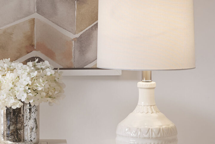 Update your space with the sleek style of the Gypsy Embossed Boho Table Lamp. The base is made from ceramic with a painted white finish for a sleek gradient look. The white