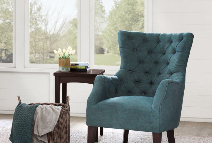 This herringbone wing back chair expresses elegance while displaying traditional elements like its button tufting and charles of london arm mixed with contemporary styling with its flared wing and tapered legs. Leg assembly required.