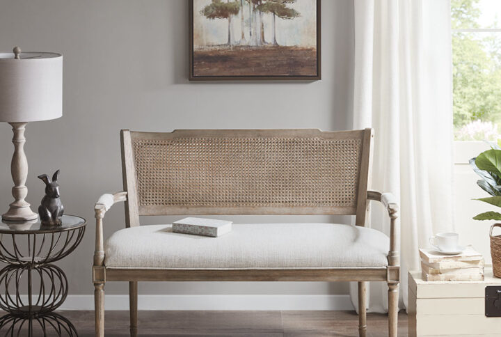 Give your living space a country charm with the Madison Park Willshire Settee. This rustic settee features pillow topped arms and an attached cushion upholstered in a beige fabric. The reclaimed natural wood finish and rattan insert on the back complement the upholstery