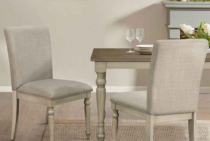 The Martha Stewart Fiona Dining Chair Set with Turned Wood Legs offers a classic farmhouse update to your dining room decor. This dining chair features an upholstered back and seat with a whitewashed solid wood frame to create a warm and welcoming allure. The solid wood legs flaunt turned and distressed details to add a rustic elegance to the design. With its simple and refined look