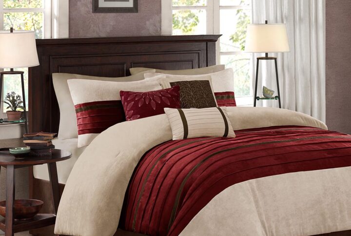 The Madison Park Palmer 7 Piece Comforter Set offers a classic and refined update to your bedroom decor. This transitional style comforter features a pieced microsuede design in rich contrasting red and khaki colors to create an incredibly soft look and feel. The 2 matching shams also flaunt a pieced construction to coordinate with the faux suede comforter. A solid brown bed skirt and 3 decorative pillows with a mix of embroidered designs add the perfect finishing touches to complete this lush traditionally-inspired comforter. Machine washable for easy care