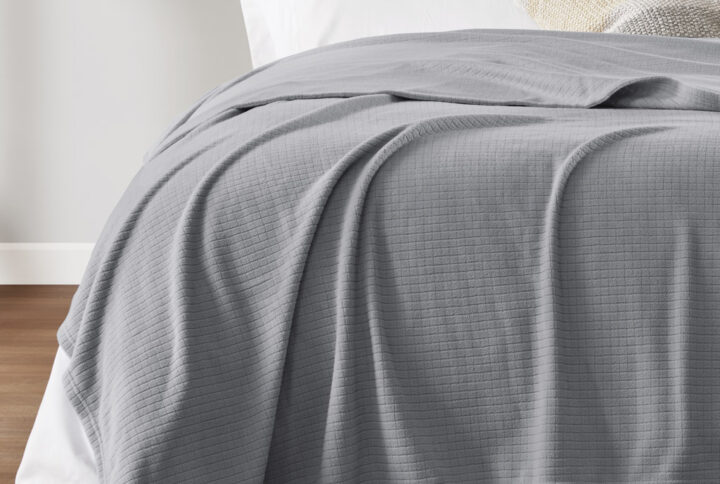 The microfleece blanket features an ultra-soft material with a subtle grid pattern to complement your decor in any room. With an anti-pilling face