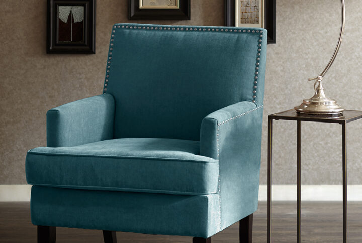 The Madison Park Colton Track Arm Club Chair brings a simple and sharp update to your home decor. This accent club chair features a sleek design with track arms and a nailhead trim along the back and sides