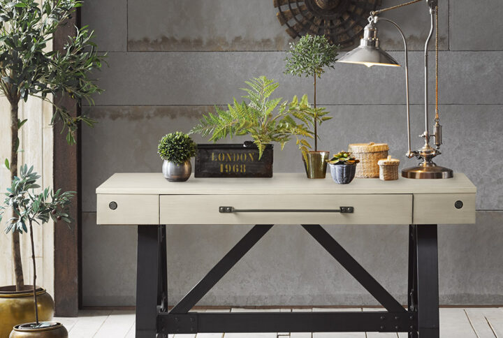 Make the INK+IVY Lancaster Desk the centerpiece for your office space. The desk features a manufactured wood top in an antique cream finish and a solid wood trestle base in a graphite finish to mimic a metal texture