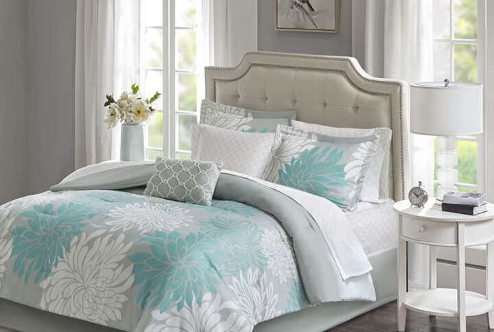 Transform your bedroom into a comfortably casual retreat with the Madison Park Essentials Maible Complete Comforter and Cotton Sheet Set. A beautiful printed floral design