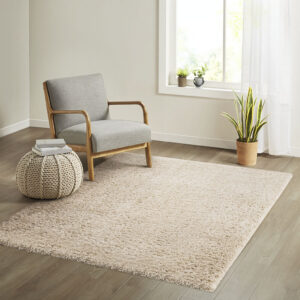 The Madison Park Camdyn Super Soft Polyester Shag Area Rug offers a chic modern addition to your living space. This solid cream shag area rug flaunts a super soft