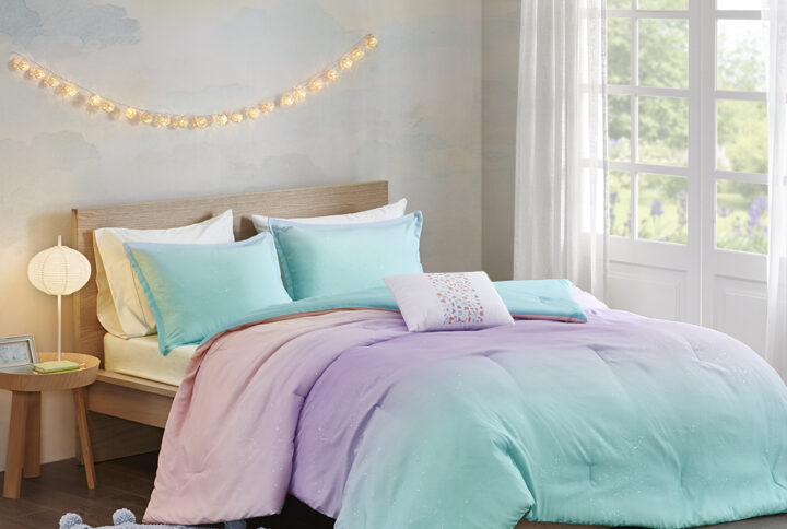 The Mi Zone Glimmer Metallic Glitter Printed Reversible Comforter Set brings a lively and colorful update to your bedroom. This ultra-soft reversible comforter features an ombre pattern of aqua