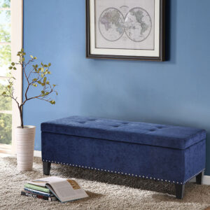 This modern storage bench accentuated with tufting provides ample storage and features an elegant blue colored soft fabric with black noir legs. Assembly Required.