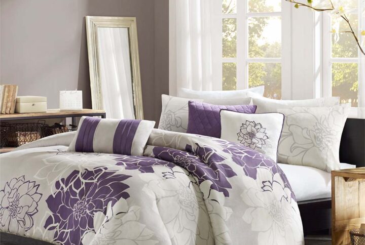 The Madison Park Lola 6 Piece Printed Duvet Cover Set transforms your bedroom into a beautiful and graceful space. A gorgeous floral print in a soft white and purple hue pops against the solid taupe grey ground cotton duvet cover and shams for a stunning transitional look. Three decorative pillows with embroidered details and fabric manipulation add texture and dimension to the bed