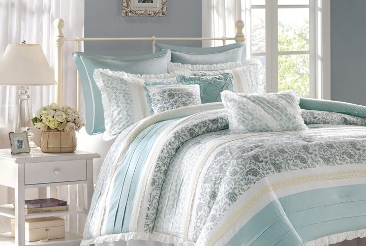 The Madison Park Dawn 9 Piece Cotton Percale Comforter Set offers a shabby chic update to your bedroom decor. A paisley print is featured on the cotton comforter with pintucked fabric separated by lace taping embellishments. Around the edge