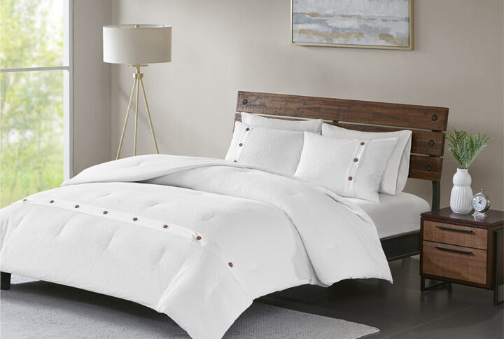 Give your bedroom a simple and clean look with the Madison Park Finely 3 Piece Cotton Waffle Weave Comforter Set. The 100% cotton comforter and shams feature a waffle weave that creates a soft textured look and feel. Decorative wood button details add a charming and functional accent. With a fresh contemporary style