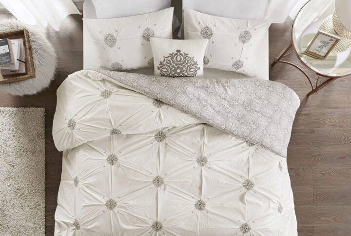 Style your bedroom with the shabby chic allure of the Madison Park Malia 4 Piece Embroidered Cotton Reversible Duvet Cover Set. The face of the reversible duvet cover features tufted grey embroidery on an ivory base