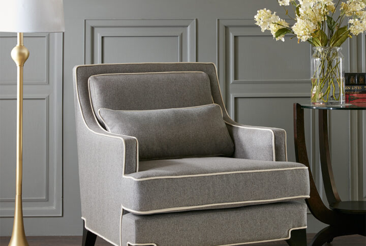 Refined and relaxed all in one chair. Grey upholstery is combined with contrasting ivory welting