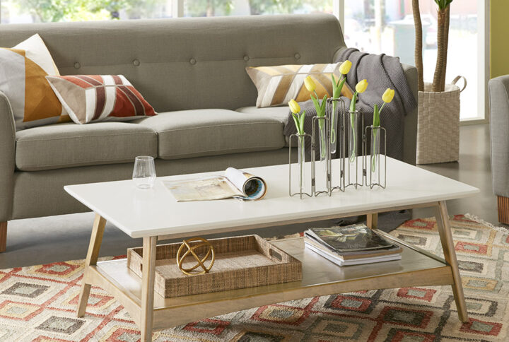 Add the bold Madison Park Parker Coffee Table to your living space. This all wooden mid-century inspired coffee table will go nicely with your living room decor. It features a Off-white finish table top composed from manufactured wood