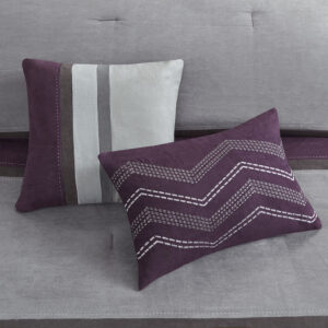 purple and charcoal grey is pieced together to create this beautiful bed. The decorative pillows are embroidered and pieced to add a decorative element to this simple