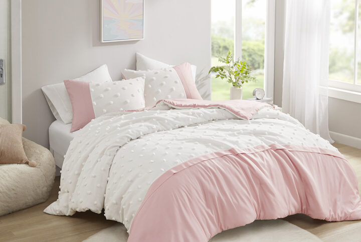 The Intelligent Design Shay duvet cover set features a vibrant colorblock design accented by clipped jacquard pompoms that add texture and charm. The duvet cover brings a pop of color to your bedroom