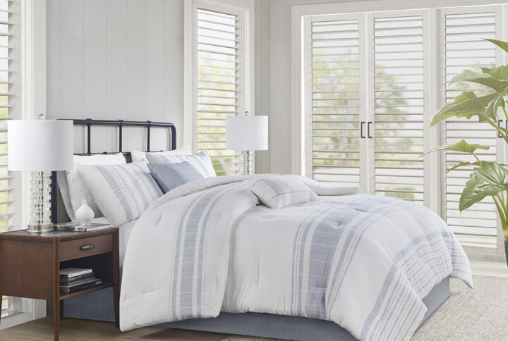 Introduce an upscale cottage charm to your bedroom with the Harbor House Morgan 6 Piece Cotton Comforter Set. This 100% cotton jacquard comforter features textured vertical woven stripes with contrasting horizontal blue stripes on white ground