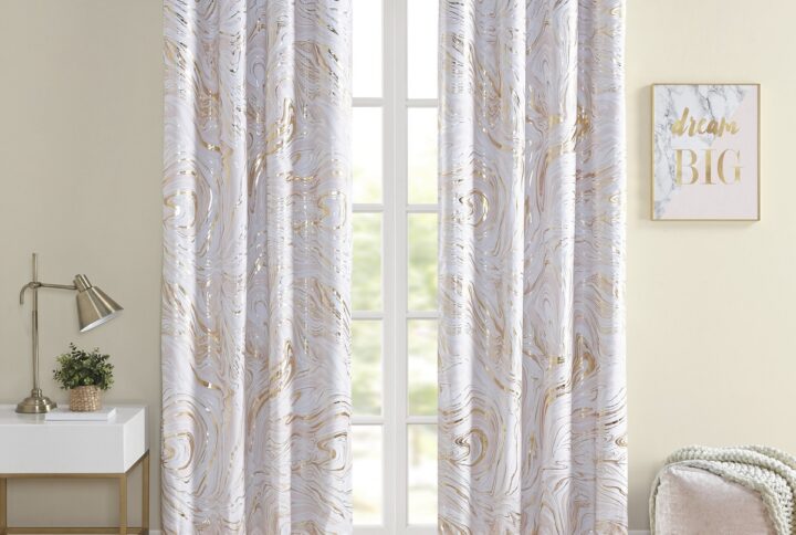 The Intelligent Design Rebecca Grommet Top Printed Marble Metallic Blackout Curtain adds a gorgeous and striking update to your bedroom décor. This window panel flaunts a gold marble metallic print on an ultra-soft blush microfiber base. Using thermal technology on the back of the curtain panel