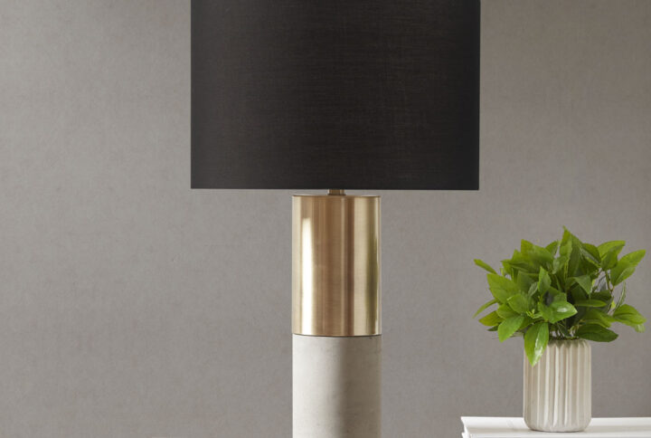 Define your space with the decadence of INK+IVY’s Fulton Concrete Table Lamp. The steel and concrete base flaunts a gold metal finish that spirals around itself for a glitzy look. A fabric drum-shaped shade lavishly complements the base with its gold hue. The 72-inch clear cord provides plenty of length to place the lamp in your living room or bedroom for extra light