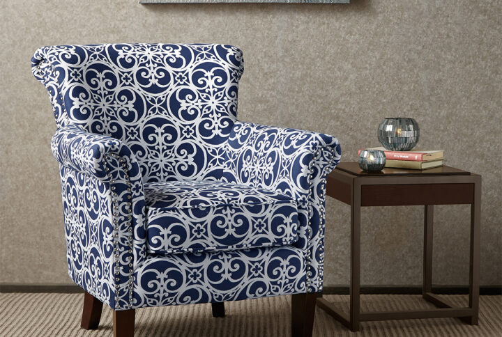 Add an eye-catching touch to your living room with the Madison Park Brooke Tight Back Club Chair. This accent chair features an all-over fretwork pattern on the upholstery that creates a stunning transitional look. The double row nailhead trim on the front of the arms and the sides of the back add an elegant accent to the design. With a comfortable loose cushion and sturdy solid wood legs