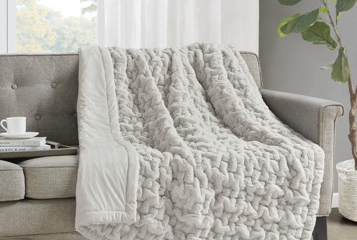 Add a modern and sophisticated touch to any space with the Madison Park Ruched Fur Throw. This throw features a solid ruched fur pattern