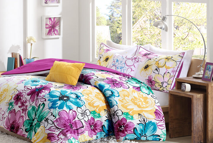 Bring a bright and cheerful update to your bedroom with the Intelligent Design Olivia Comforter Set. The comforter and shams (1 in Twin/TwinXL) flaunts bright colors and an asymmetrical floral print to invigorate your space with striking style. A solid fuchsia reverse complements the top of the bed. The 2 decorative pillows feature floral embroidery and fabric manipulation