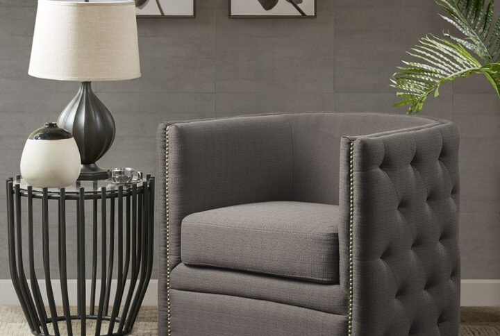 Upgrade your living room with this Madison Park tufted barrel swivel chair. Its curved back and arms