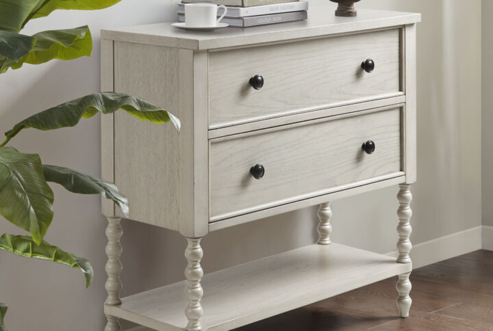 Elevate your living room with the sophisticated style of the Madison Park Signature Beckett Accent Chest. This 2-drawer accent chest features a solid wood frame and elegant turned legs