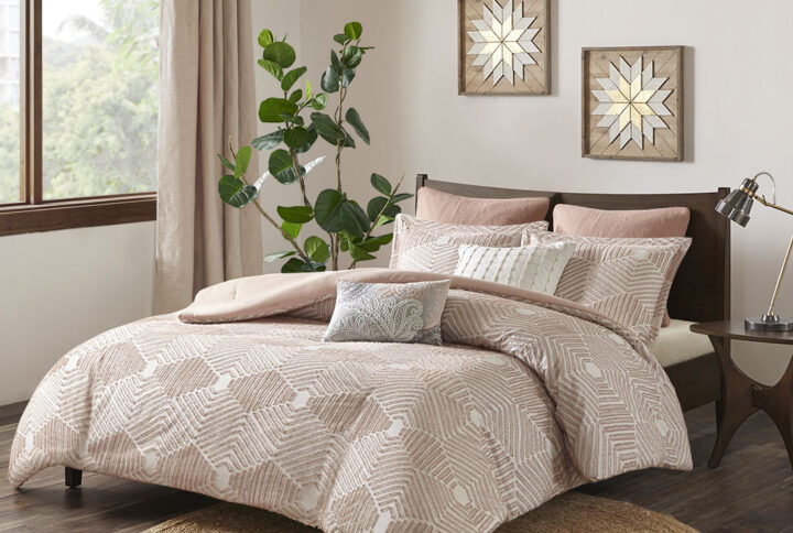 Add a rich textural look to your bedroom with the INK+IVY Ellipse Cotton Jacquard Comforter Set. The cotton comforter features a geometric design in a blush clipped jacquard with a solid blush reverse that complements the top of the bed