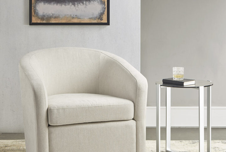 Curl up with a good book and relax in the Martha Stewart Amber Swivel Chair. Upholstered in a soft ivory fabric