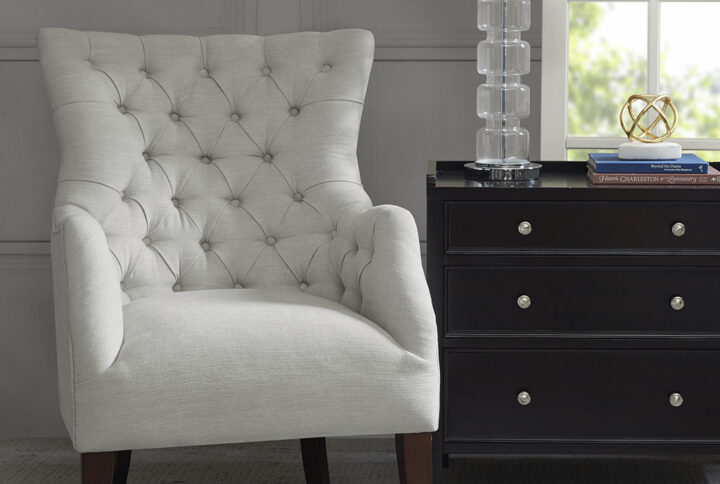 This herringbone wing back chair expresses elegance while displaying traditional elements like its button tufting and charles of london arm mixed with contemporary styling with its flared wing and tapered legs. Leg assembly required.