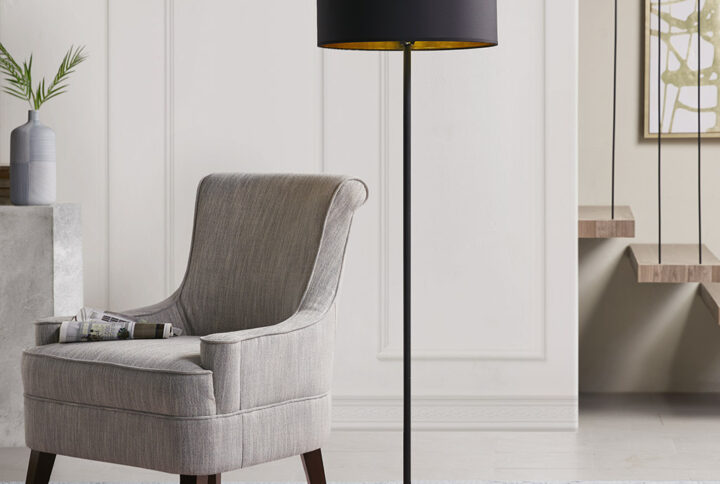 Elevate your home decor with the bold look of the Martha Stewart Hunts Metal Floor Lamp. This floor lamp features a slender metal stem with a black finish and a round