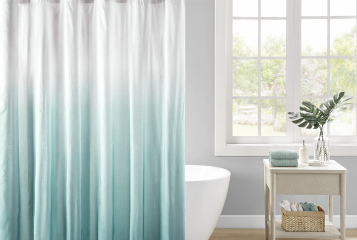 Add a refreshing touch to your bathroom decor with our Madison Park Ara Ombre Printed Seersucker Shower Curtain. This shower curtain features an aqua ombre print on an embossed seersucker fabric