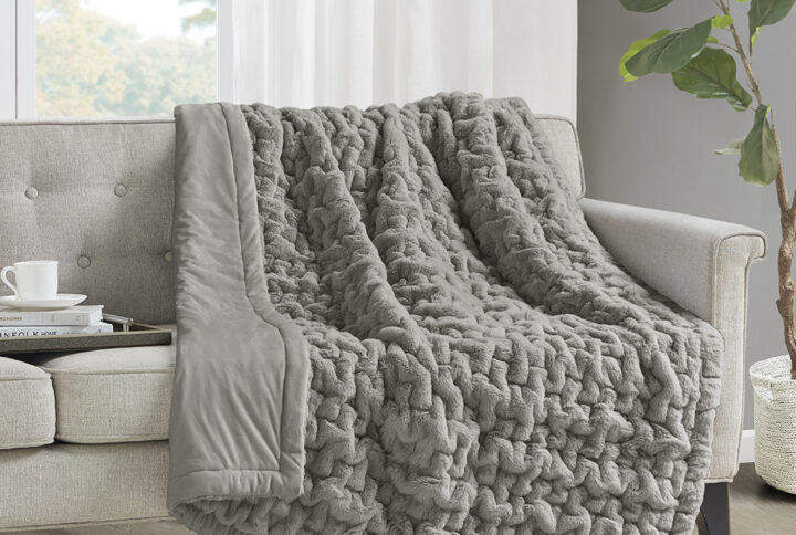 Add a modern and sophisticated touch to any space with the Madison Park Ruched Fur Throw. This throw features a solid ruched fur pattern