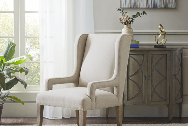 The Madison Park Whinney Accent Chair offers sleek and sophisticated update for your living space. Subtle and elegant curves on the high back create a simple yet stunning look. The light grey upholstery is beautifully complemented by the reclaimed grey wood finish on the solid wood legs