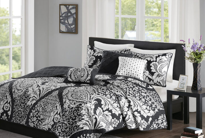 The Madison Park Vienna 6 Piece Reversible Quilt Set offers an eye-catching update to your bedroom decor. A beautifully intricate damask pattern is flaunted across the quilted quilt and shams