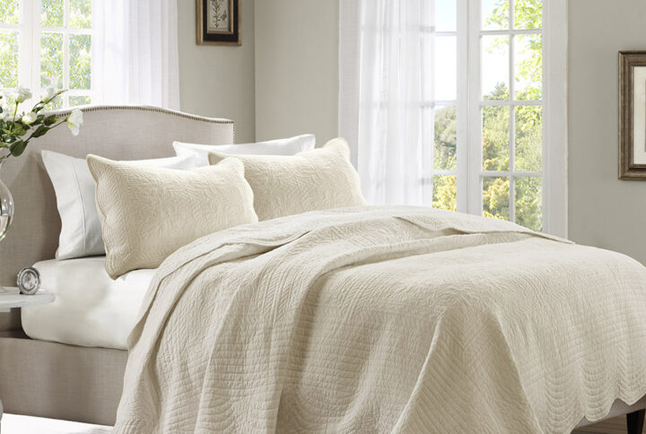 The Madison Park Tuscany 3 Piece Reversible Scalloped Edge Quilt Set is perfect as a layering piece or as an alternative to your comforter for a charming country look. The quilt and shams flaunt a classic stitch pattern with scalloped edges that add an elegant touch to your bedroom. This reversible quilt is filled with cotton filling and features a soft microfiber face