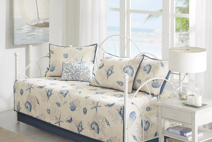 Create a coastal getaway right in your guest room with the Madison Park Bayside 6 Piece Reversible Daybed Cover Set. This quilted daybed features assorted blue seashells and a coral print with a solid blue reverse
