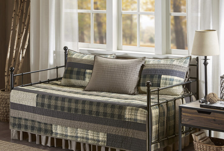 Turn your guest bedroom into an inviting and cozy space with the Woolrich Winter Plains 5 Piece Daybed Cover Set. This quilted daybed cover features a mix of solid and plaid prints with a solid tan reverse to create a classic lodge look. The 3 reversible shams repeat the design seen on the daybed and feature tie closures on the sides that add a charming accent. A solid tan bedskirt adds the finishing touch to this cabin style daybed set. Machine washable for easy care