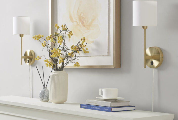Bring classic beauty to your home with the 510 Design Conway Metal Wall Sconce with Cylinder Shade. Each sconce