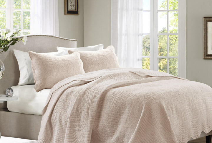 The Madison Park Tuscany 3 Piece Reversible Scalloped Edge Quilt Set is perfect as a layering piece or as an alternative to your comforter for a charming country look. The quilt and shams flaunt a classic stitch pattern with scalloped edges that add an elegant touch to your bedroom. This reversible quilt is filled with cotton filling and features a soft microfiber face
