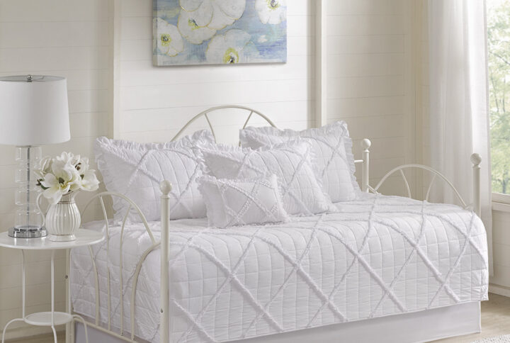 The Madison Park Rosie 6 Piece Daybed Cover Set provides the perfect balance between comfort and style. This quilted daybed cover features pleating details with a ruffle overlay in a diamond pattern to create an elegant and airy look. The 3 matching shams have ruffle edges to coordinate with the lofty design of the daybed cover. An oblong decorative pillow with ruffle details and a solid white bedskirt provide the finishing touches to complete this daybed cover set. The daybed cover easily fits a Twin size mattress.