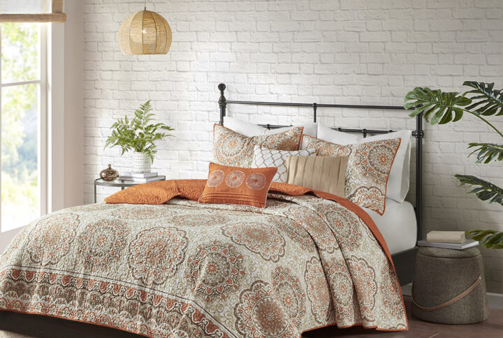 Tangiers 6 Piece Reversible Quilt Set instantly adds color and flair to your bedroom. Its bold orange and taupe floral print with large medallions is a modern twist to a classic look. The embroidered detailing on the three decorative pillows pulls the whole look together. This quilt set also includes two matching standard shams. With a microfiber polyester face and a brushed fabric reverse