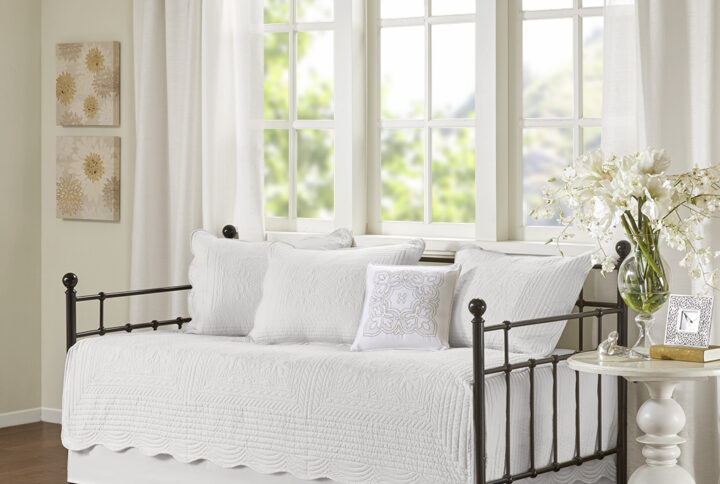 The Madison Park Tuscany 6 Piece Reversible Scalloped Edge Daybed Cover Set offers a charming cottage-inspired update to your guest bedroom. The daybed cover and 3 shams flaunt a classic stitch pattern with scalloped edges that add an elegant touch to your bedroom. A square decorative pillow with elegant embroidery and solid bed skirt add the finishing touches to the daybed set. This country daybed cover also has an antimicrobial treatment that provides built-in freshness protection