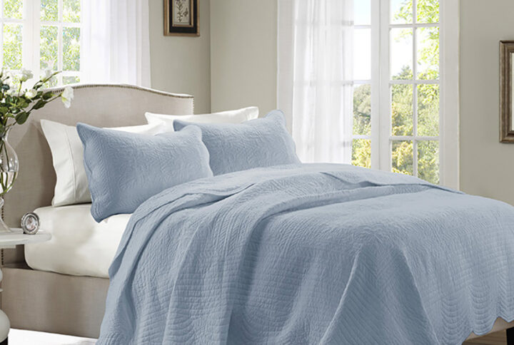 The Madison Park Tuscany 3 Piece Reversible Scalloped Edge Quilt Set is perfect as a layering piece or as an alternative to your comforter for a charming country look. The quilt and shams flaunt a classic stitch pattern with scalloped edges that add an elegant touch to your bedroom. This reversible quilt is filled with cotton filling and features a soft microfiber face